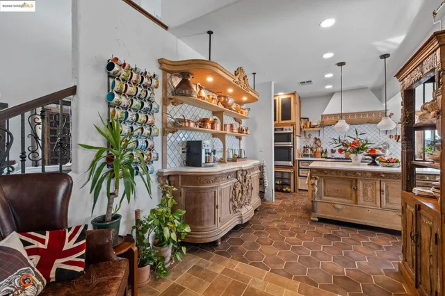 a kitchen with stove and cabinets