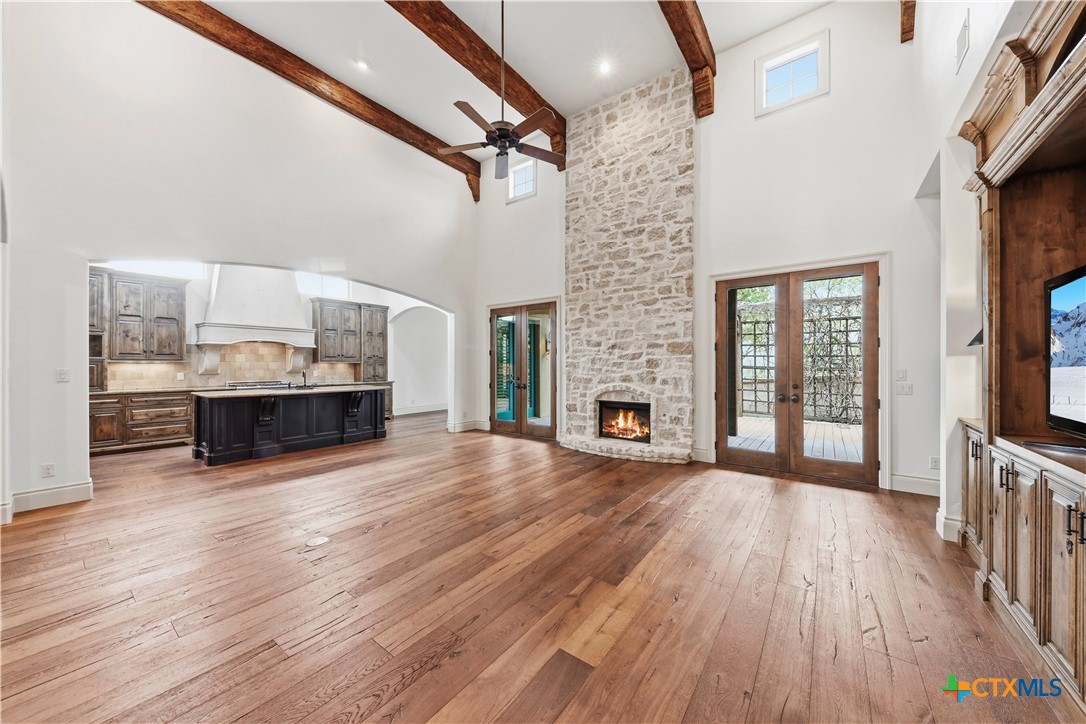 1108 Tuscan Ridge Drive New Braunfels, TX 78130 - Photo 11 of 47 a view of empty room with wooden floor and fireplace