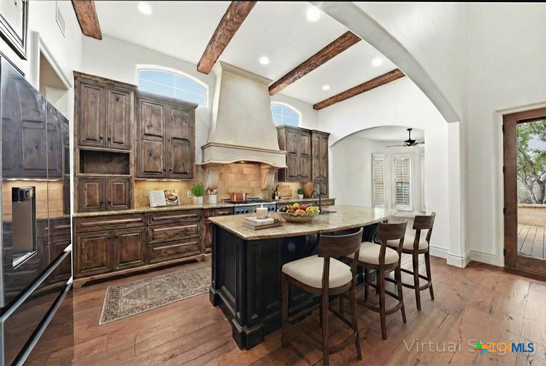 1108 Tuscan Ridge Drive New Braunfels, TX 78130 - Photo 13 of 47 a kitchen with stainless steel appliances kitchen island granite countertop a table chairs sink and cabinets