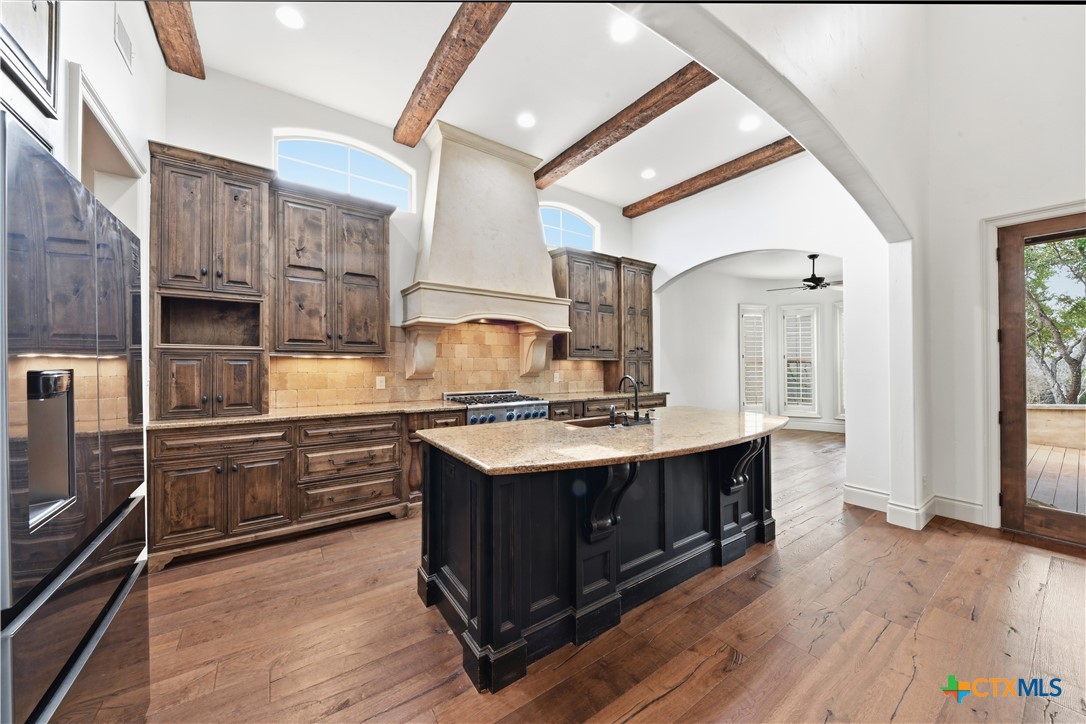 1108 Tuscan Ridge Drive New Braunfels, TX 78130 - Photo 14 of 47 a kitchen with stainless steel appliances granite countertop a sink stove and refrigerator