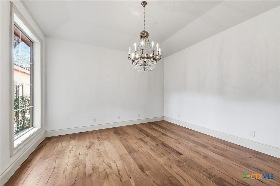 1108 Tuscan Ridge Drive New Braunfels, TX 78130 - Photo 18 of 47 a view of a room with wooden floor and a window