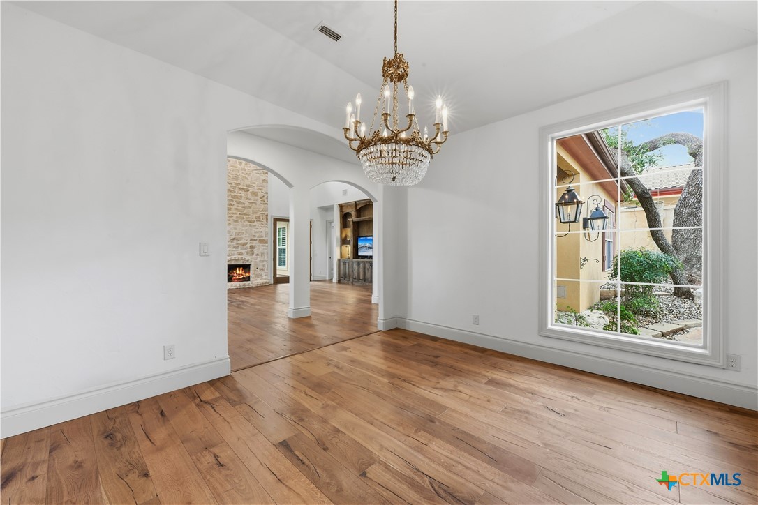 1108 Tuscan Ridge Drive New Braunfels, TX 78130 - Photo 19 of 47 a view of a big room with wooden floor chandelier and windows
