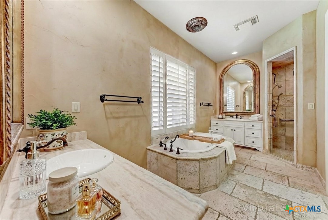 1108 Tuscan Ridge Drive New Braunfels, TX 78130 - Photo 25 of 47 a spacious bathroom with a tub sink and mirror