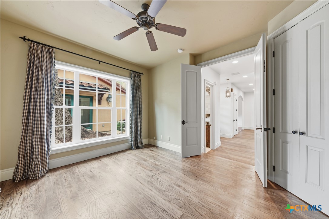 1108 Tuscan Ridge Drive New Braunfels, TX 78130 - Photo 27 of 47 a view of empty room with wooden floor and fan