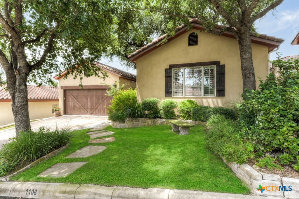 1108 Tuscan Ridge Drive New Braunfels, TX 78130 - Photo 3 of 47 a front view of a house with a yard and garage