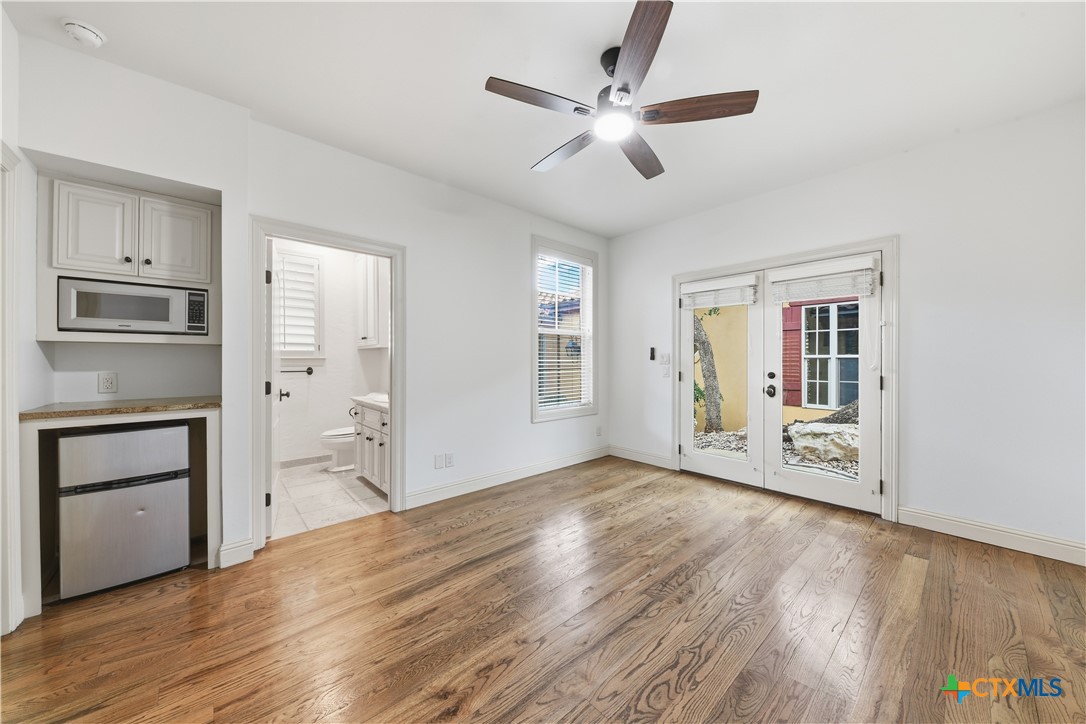1108 Tuscan Ridge Drive New Braunfels, TX 78130 - Photo 37 of 47 a view of an empty room with a window and wooden floor