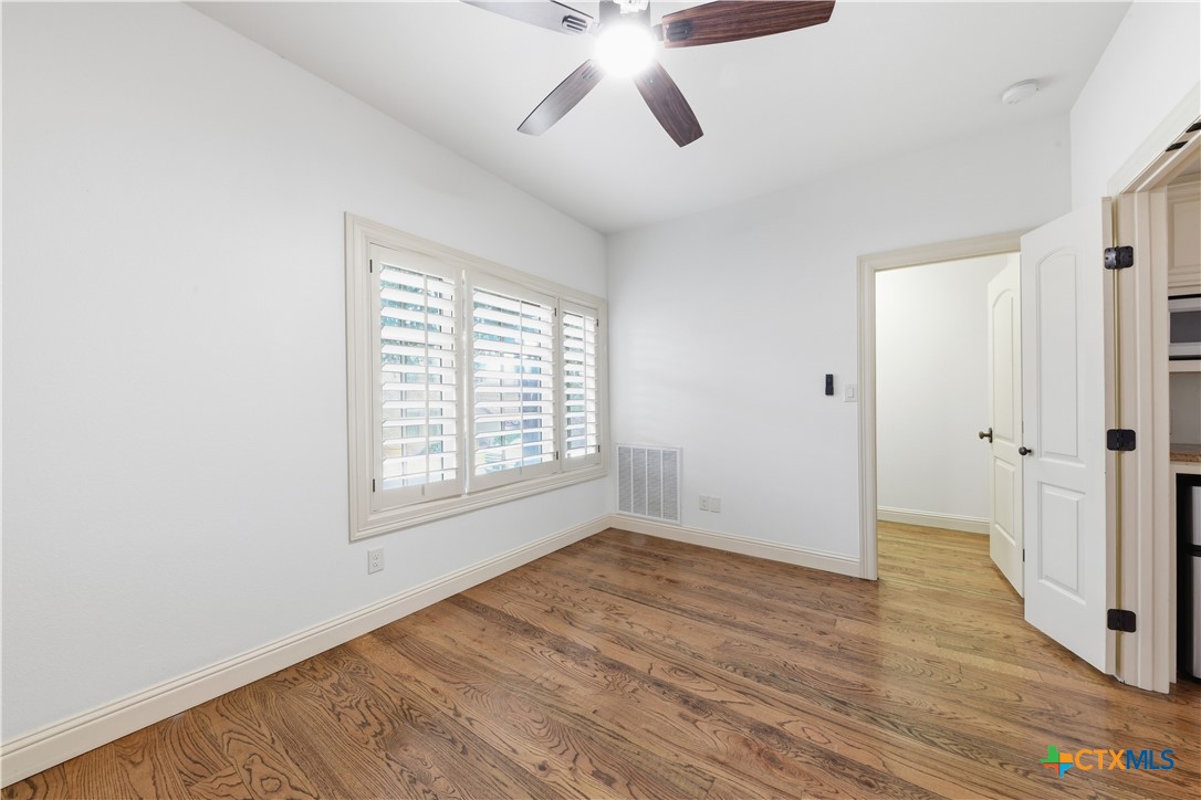 1108 Tuscan Ridge Drive New Braunfels, TX 78130 - Photo 39 of 47 a view of an empty room with wooden floor and window