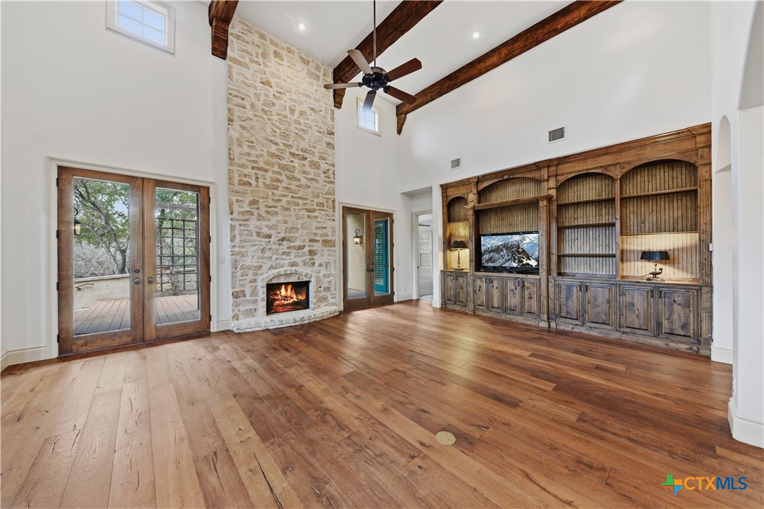 1108 Tuscan Ridge Drive New Braunfels, TX 78130 - Photo 9 of 47 a view of empty room with wooden floor and fireplace