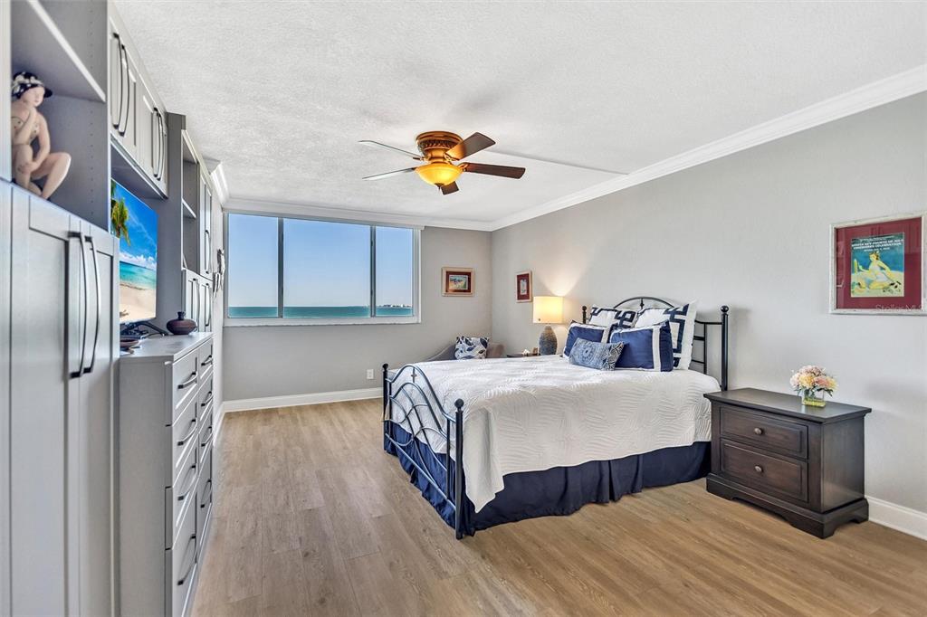 4822 Ocean Boulevard, Unit 8D Siesta Key, FL 34242 - Photo 25 of 69 a bedroom with a bed and a chandelier