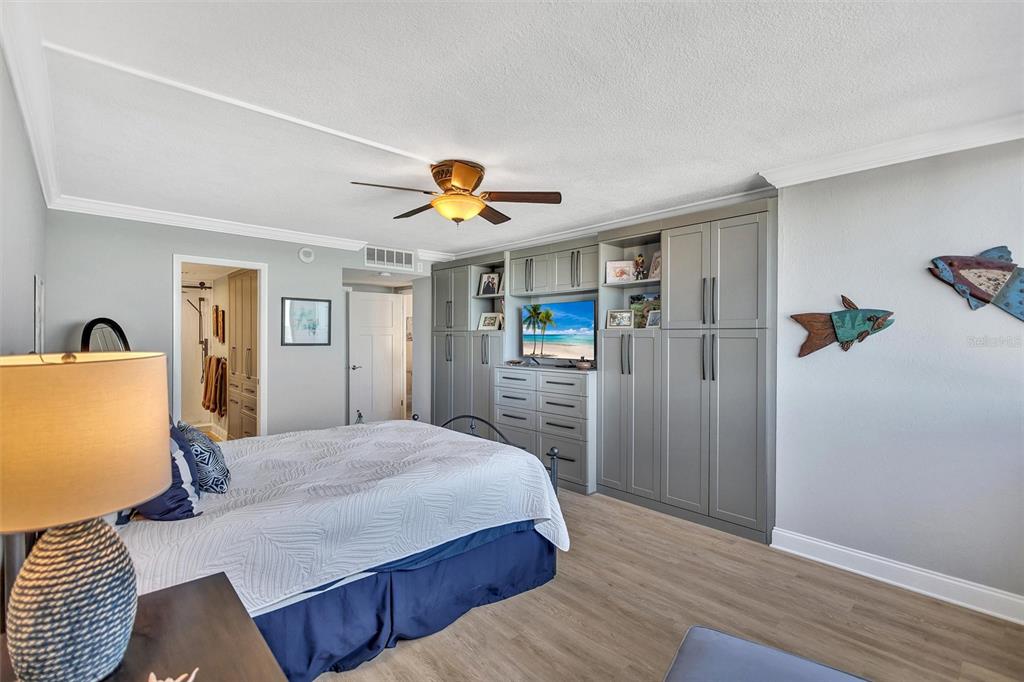 4822 Ocean Boulevard, Unit 8D Siesta Key, FL 34242 - Photo 27 of 69 a bedroom with a bed and wooden floor