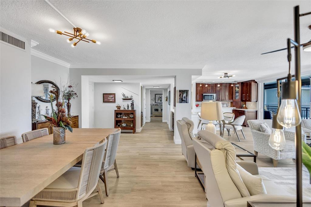 4822 Ocean Boulevard, Unit 8D Siesta Key, FL 34242 - Photo 31 of 69 a view of a dining room and livingroom with furniture wooden floor a chandelier