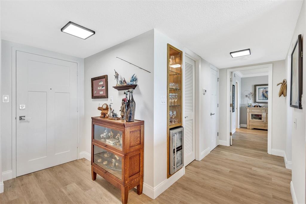 4822 Ocean Boulevard, Unit 8D Siesta Key, FL 34242 - Photo 32 of 69 a view of a hallway with bathroom and wooden floor