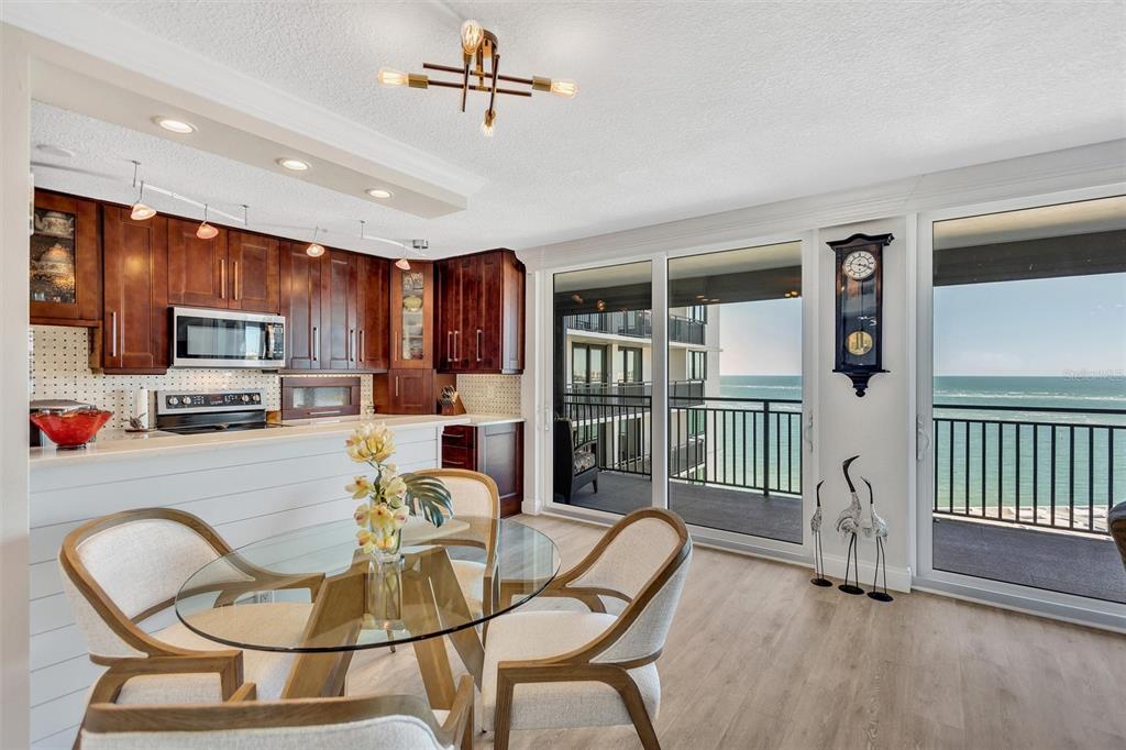 4822 Ocean Boulevard, Unit 8D Siesta Key, FL 34242 - Photo 33 of 69 a dining room with furniture a chandelier and window