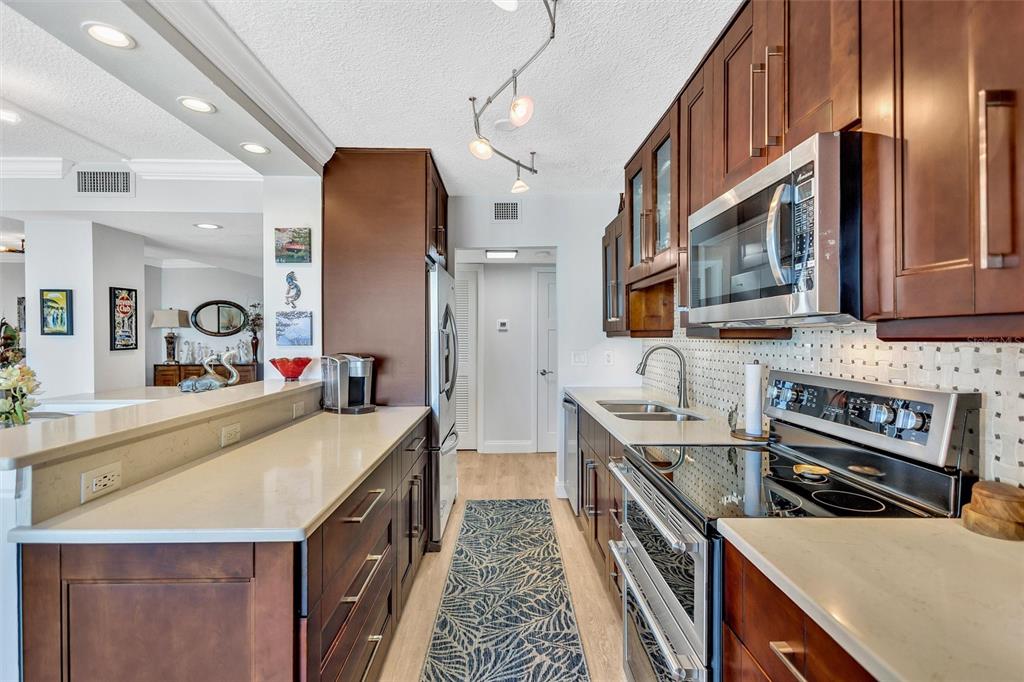 4822 Ocean Boulevard, Unit 8D Siesta Key, FL 34242 - Photo 36 of 69 a kitchen with stainless steel appliances granite countertop a sink and stove