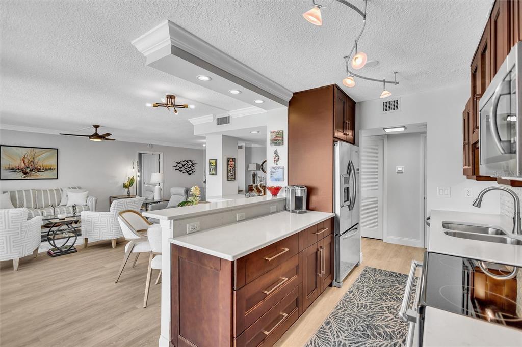 4822 Ocean Boulevard, Unit 8D Siesta Key, FL 34242 - Photo 37 of 69 a large kitchen with kitchen island a sink appliances and a dining table view