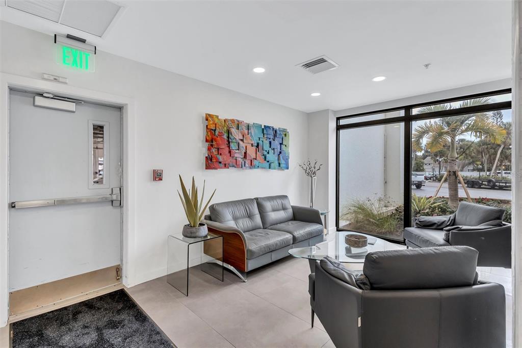 4822 Ocean Boulevard, Unit 8D Siesta Key, FL 34242 - Photo 49 of 69 a living room with furniture and a large window