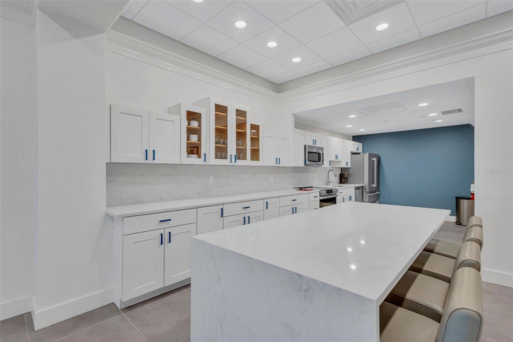 4822 Ocean Boulevard, Unit 8D Siesta Key, FL 34242 - Photo 54 of 69 a kitchen with a sink and cabinets