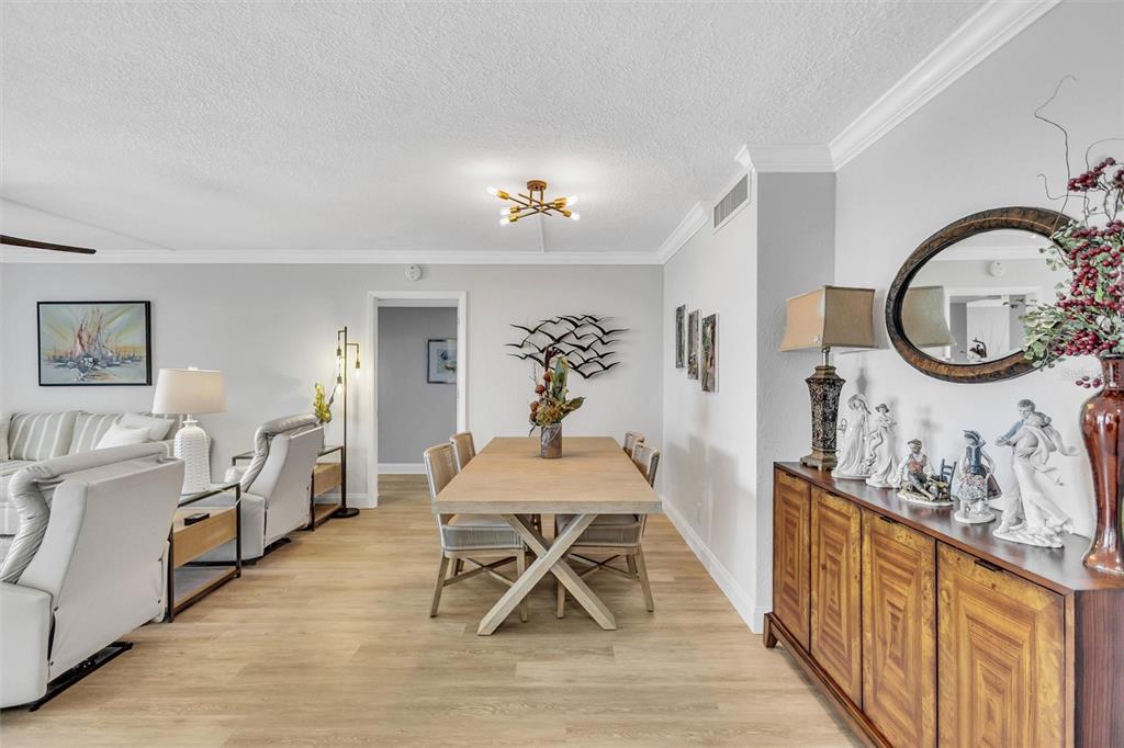 4822 Ocean Boulevard, Unit 8D Siesta Key, FL 34242 - Photo 9 of 69 a dining room with wooden floor and furniture