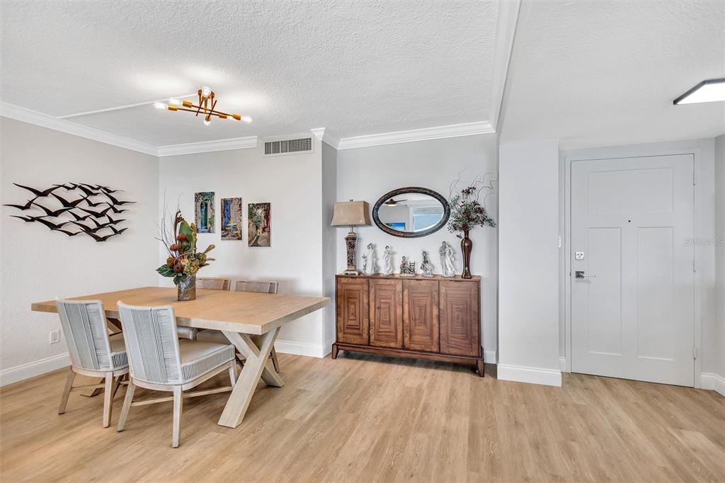 4822 Ocean Boulevard, Unit 8D Siesta Key, FL 34242 - Photo 10 of 69 a view of a dining room with furniture and wooden floor