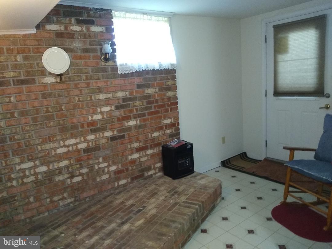 9545 Dubois Road Charlotte Hall, MD 20622 - Photo 21 of 32 Basement Hearth for wood stove