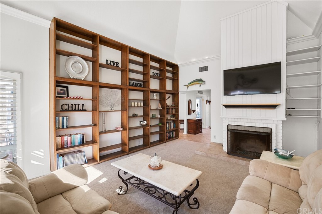 23892 Taranto Bay Dana Point, CA 92629 - Photo 11 of 73 a living room with furniture a flat screen tv and a fireplace