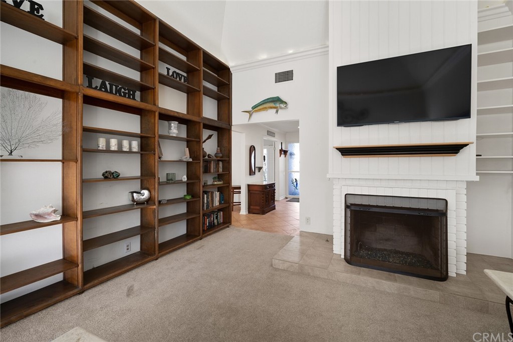 23892 Taranto Bay Dana Point, CA 92629 - Photo 14 of 73 a living room with a flat screen tv and a fireplace