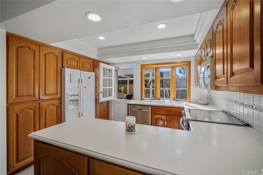 23892 Taranto Bay Dana Point, CA 92629 - Photo 18 of 73 a kitchen with refrigerator and large window
