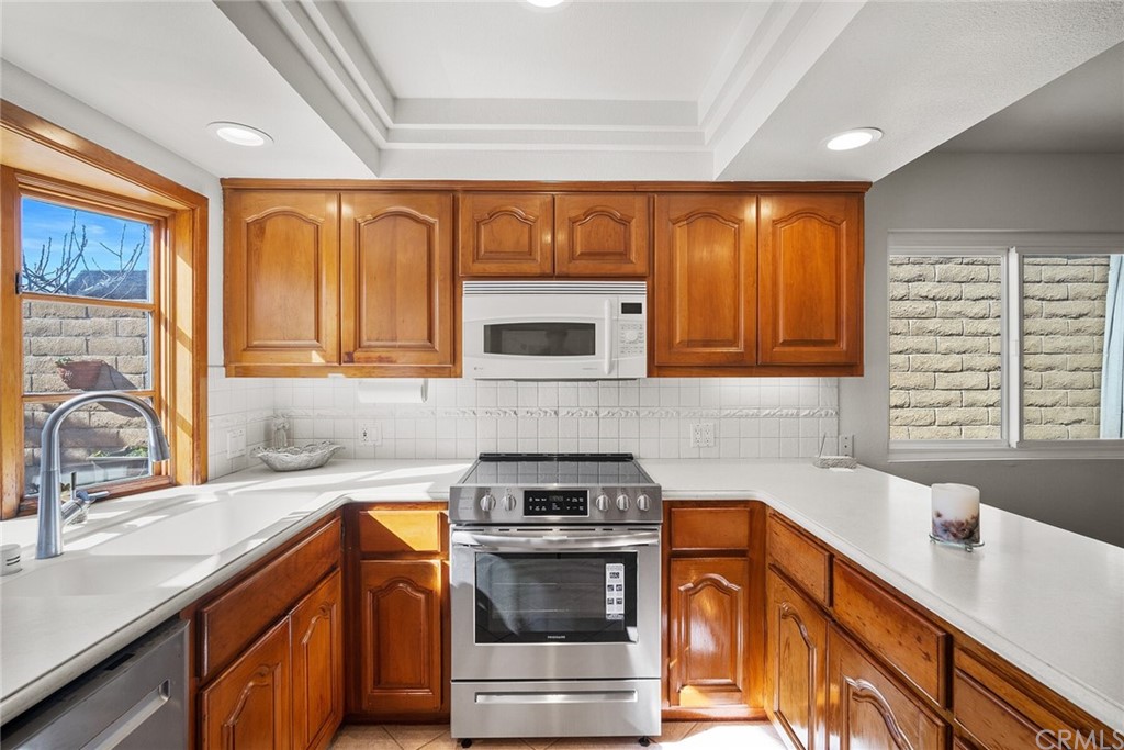 23892 Taranto Bay Dana Point, CA 92629 - Photo 19 of 73 a kitchen with stainless steel appliances granite countertop a sink stove and cabinets