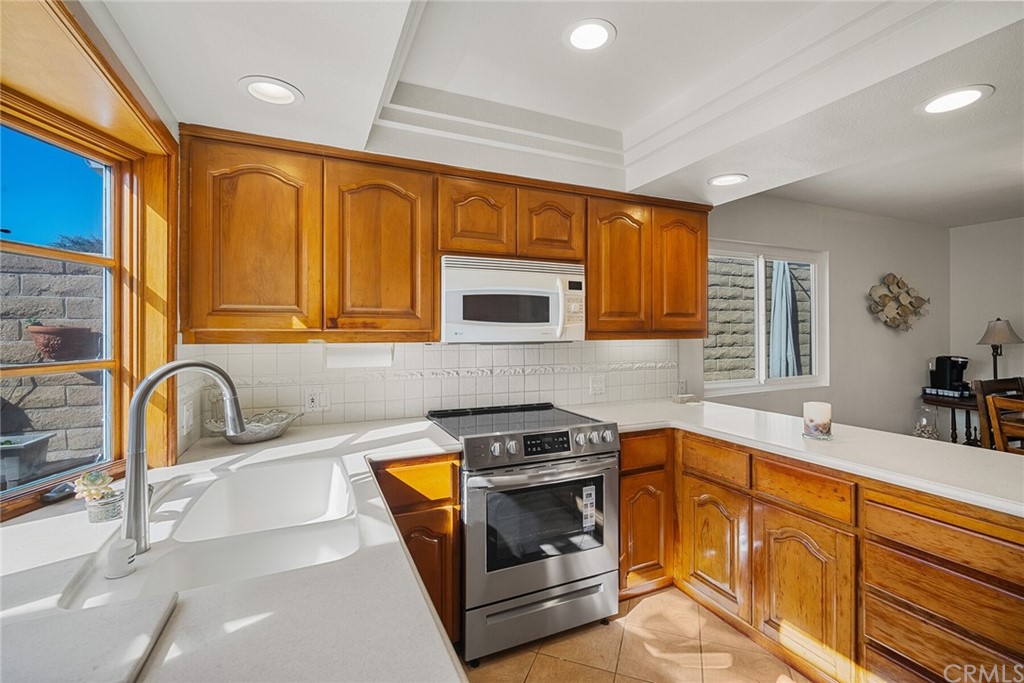 23892 Taranto Bay Dana Point, CA 92629 - Photo 20 of 73 a kitchen with granite countertop a sink a stove and cabinets