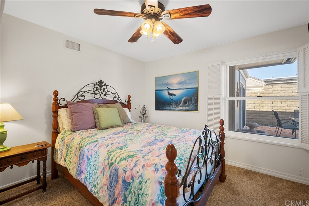 23892 Taranto Bay Dana Point, CA 92629 - Photo 25 of 73 a bedroom with a bed and a chandelier