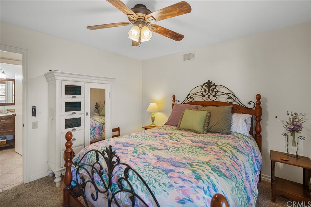 23892 Taranto Bay Dana Point, CA 92629 - Photo 26 of 73 a bedroom with a bed and a chandelier
