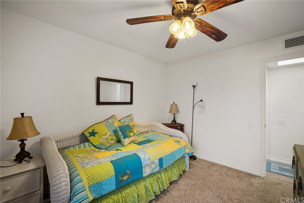 23892 Taranto Bay Dana Point, CA 92629 - Photo 29 of 73 a bedroom with a bed and a chandelier