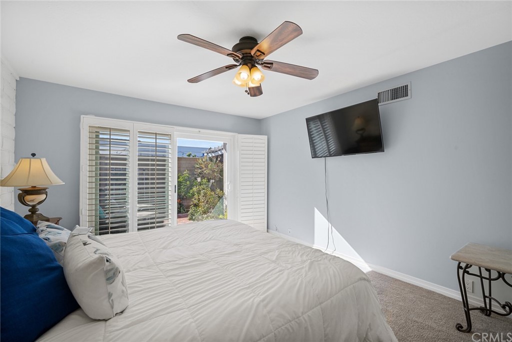 23892 Taranto Bay Dana Point, CA 92629 - Photo 32 of 73 a bedroom with a bed a flat screen tv and a window