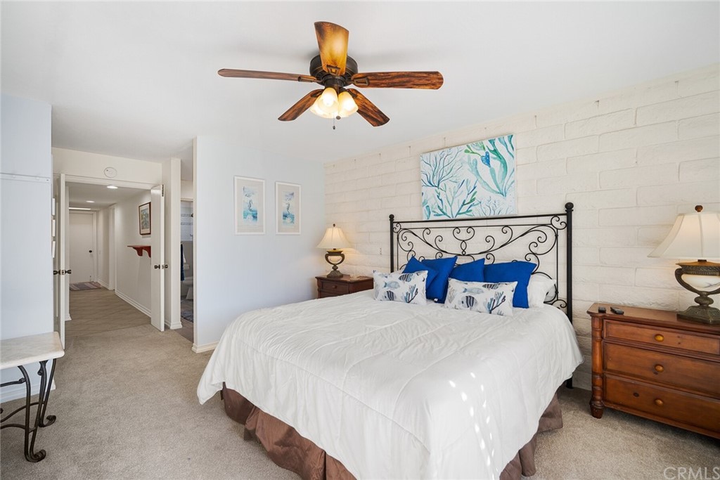 23892 Taranto Bay Dana Point, CA 92629 - Photo 33 of 73 a bedroom with a bed and a chandelier