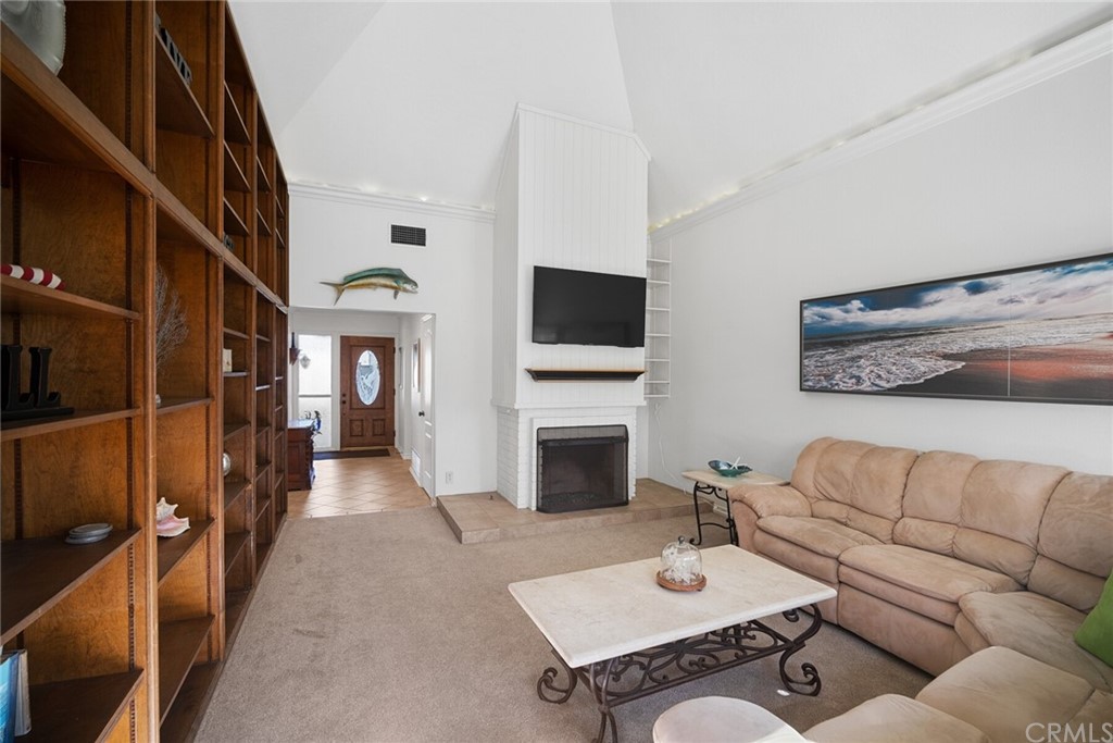 23892 Taranto Bay Dana Point, CA 92629 - Photo 9 of 73 a living room with furniture a fireplace and a flat screen tv