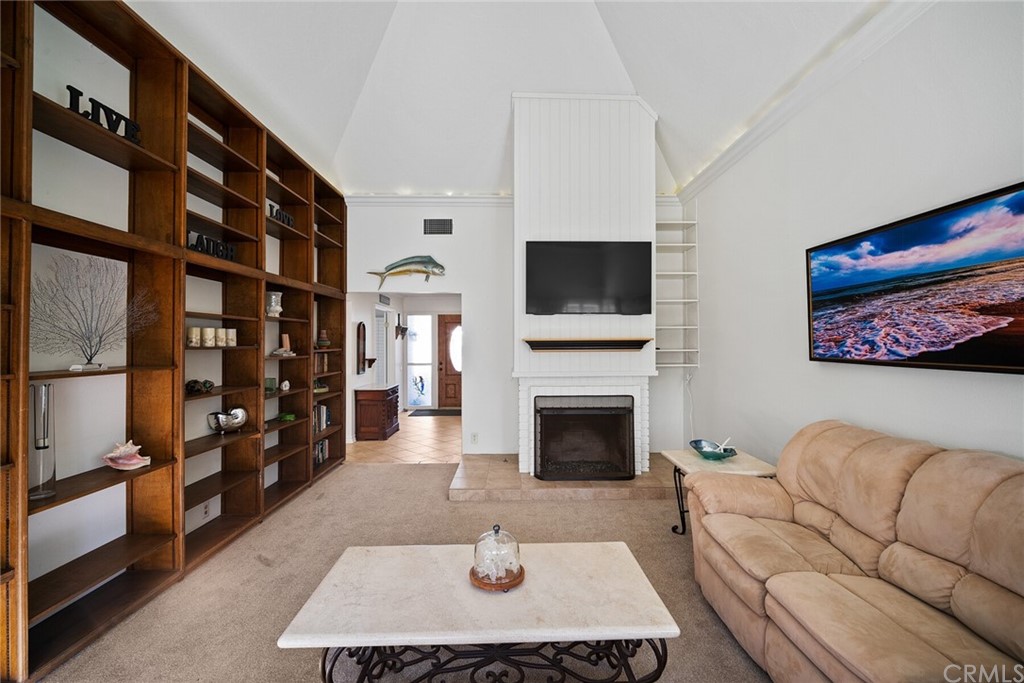 23892 Taranto Bay Dana Point, CA 92629 - Photo 10 of 73 a living room with furniture a rug and a fireplace