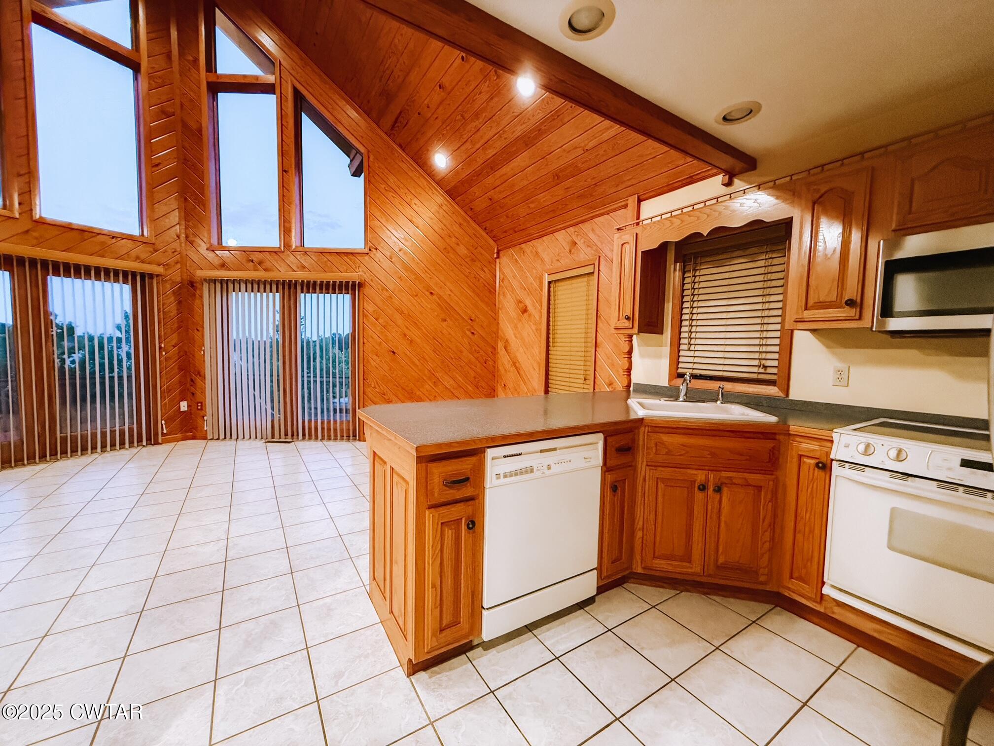 3490 Coffee Landing Road Morris Chapel, TN 38361 - Photo 11 of 39 a kitchen with stainless steel appliances granite countertop a stove a sink and a microwave