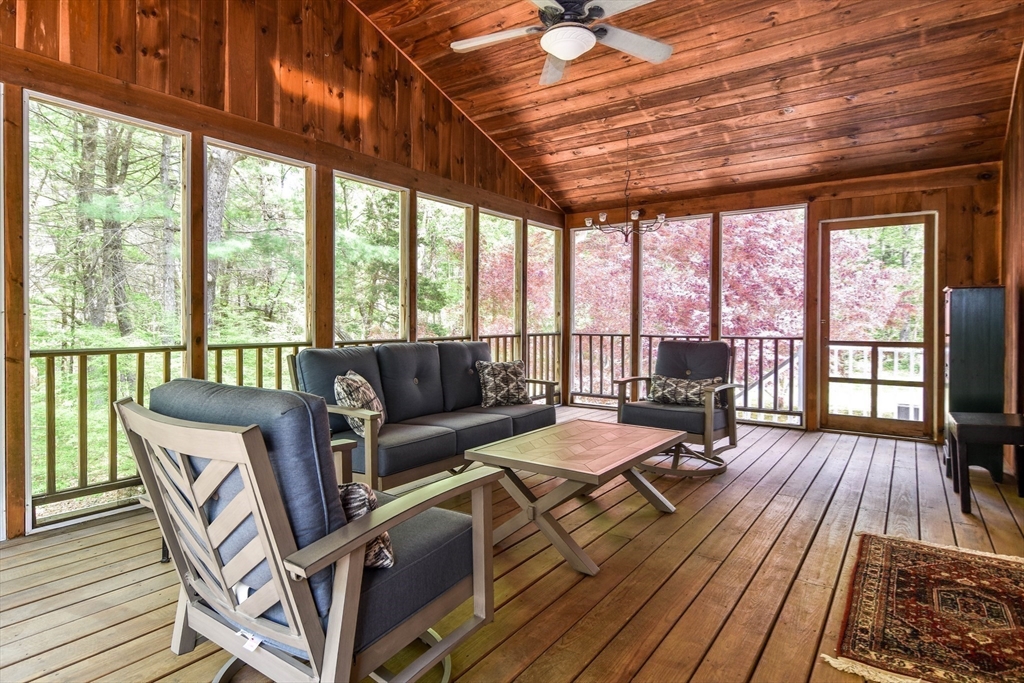 114 Hunters Ridge Road Concord, MA 01742 - Photo 20 of 38 a living room with furniture a wooden floor and a large window