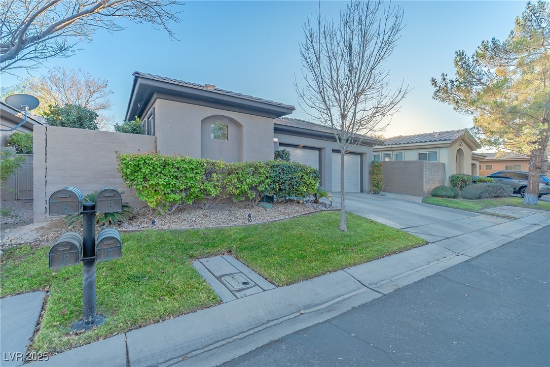 17 Chatmoss Road Henderson, NV 89052 - Photo 2 of 58 Single story home featuring fence, concrete driveway, a front yard, stucco siding, and a garage
