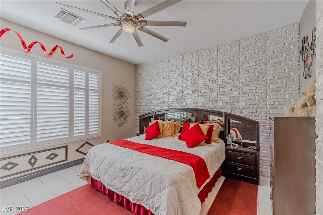 17 Chatmoss Road Henderson, NV 89052 - Photo 23 of 58 Bedroom with tile patterned floors, visible vents, and ceiling fan