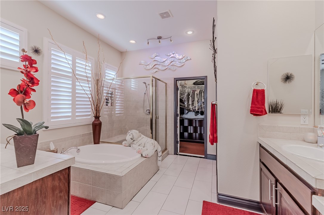 17 Chatmoss Road Henderson, NV 89052 - Photo 24 of 58 Full bath featuring vanity, tile patterned floors, a stall shower, visible vents, and a garden tub
