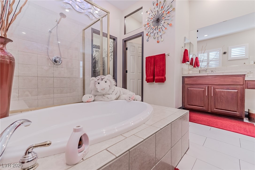17 Chatmoss Road Henderson, NV 89052 - Photo 26 of 58 Full bathroom with tile patterned floors, vanity, a bath, and a stall shower