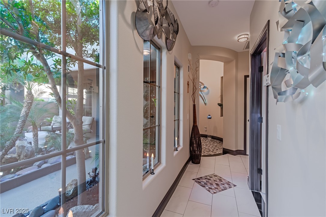 17 Chatmoss Road Henderson, NV 89052 - Photo 28 of 58 Hall featuring light tile patterned floors and arched walkways