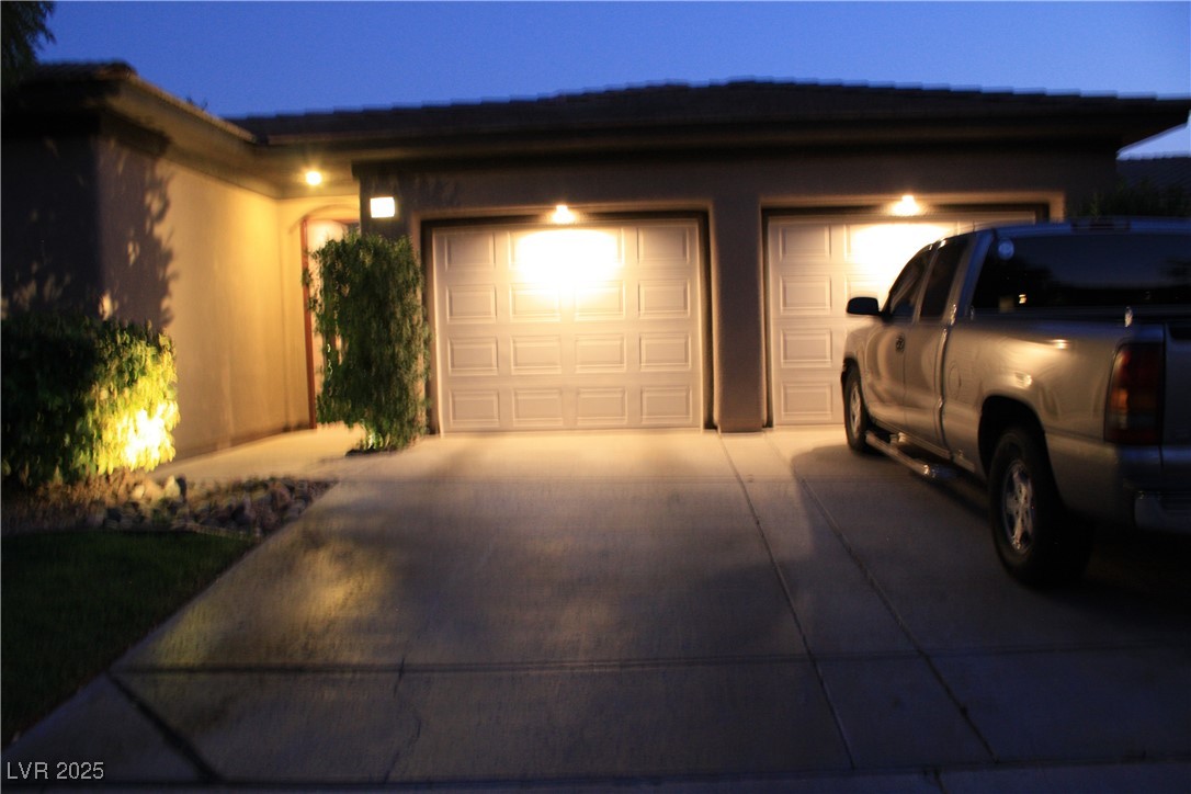 17 Chatmoss Road Henderson, NV 89052 - Photo 3 of 58 Garage at night with concrete driveway