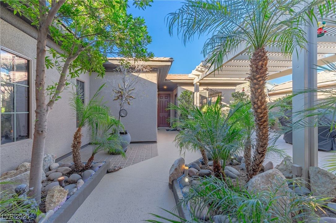 17 Chatmoss Road Henderson, NV 89052 - Photo 5 of 58 View of side of property with stucco siding and a pergola