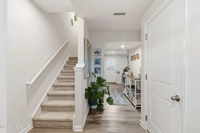 a view of entryway and hall with wooden floor