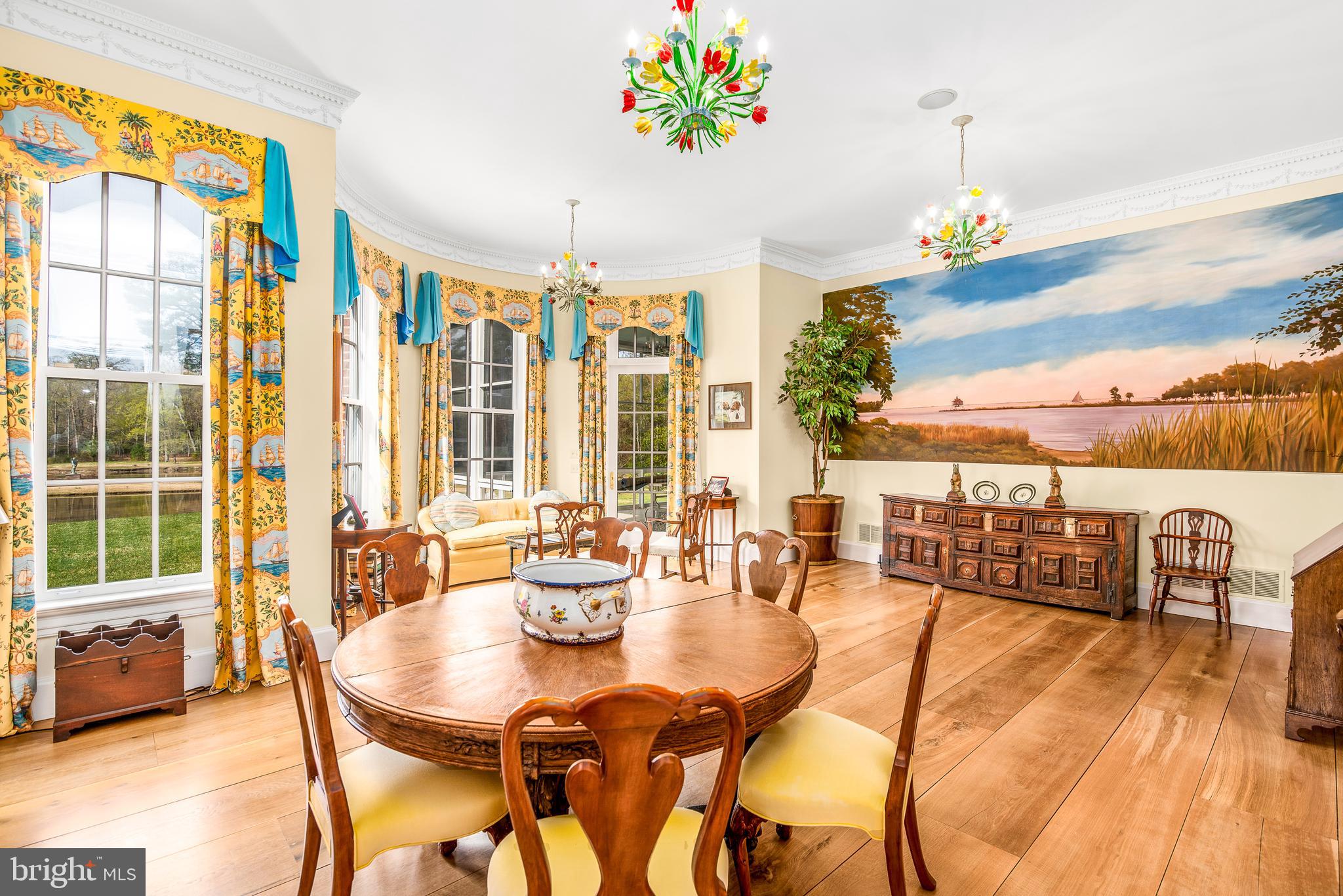 11470 Wye Heights Road Easton, MD 21601 - Photo 22 of 61 a view of a dining room with furniture a chandelier and wooden floor