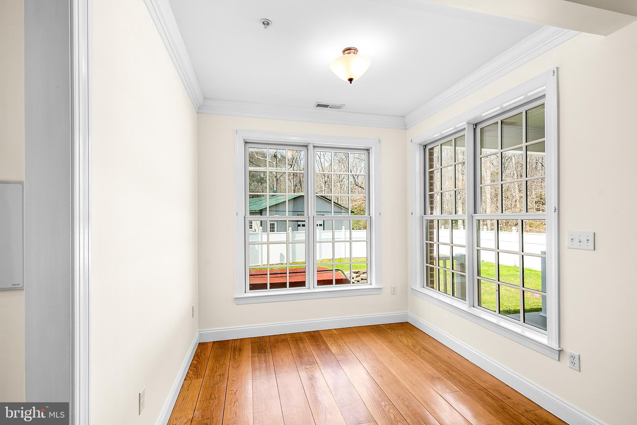 11470 Wye Heights Road Easton, MD 21601 - Photo 57 of 61 a view of an empty room with a window and wooden floor