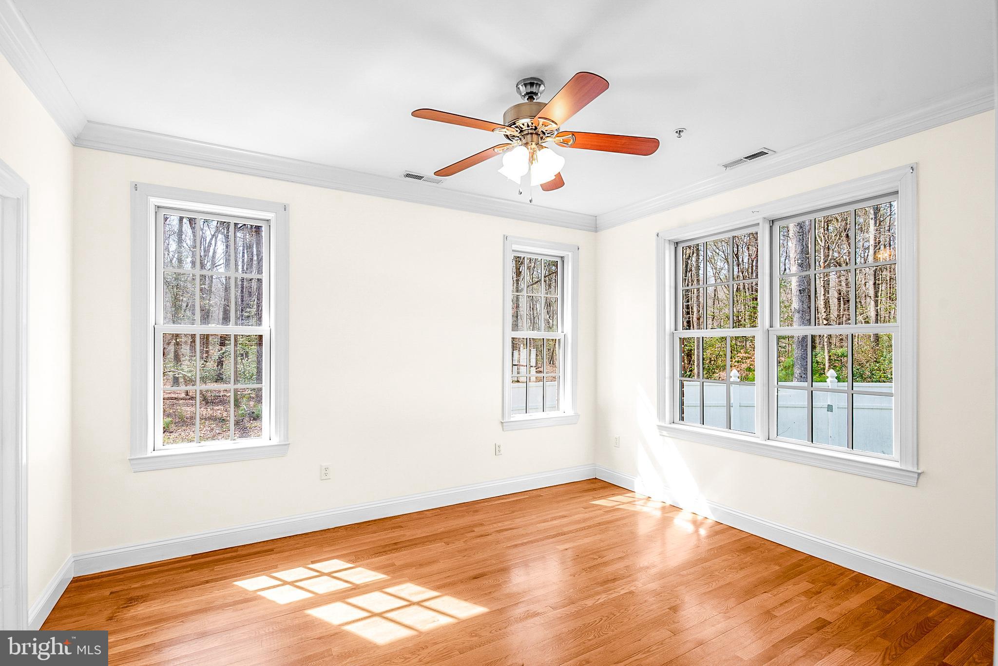 11470 Wye Heights Road Easton, MD 21601 - Photo 59 of 61 a view of an empty room with wooden floor and a window