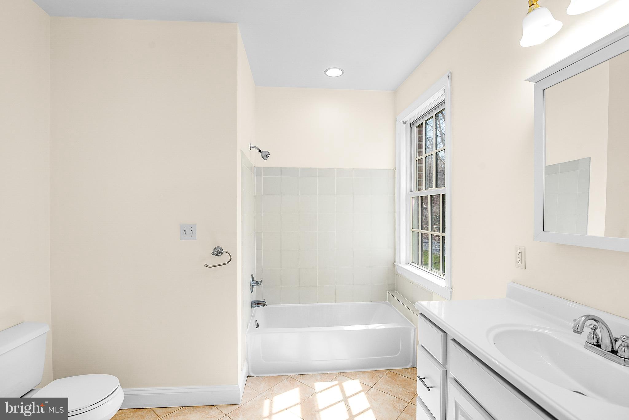 11470 Wye Heights Road Easton, MD 21601 - Photo 60 of 61 a bathroom with a bathtub sink vanity mirror and toilet